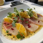 hamachi crudo served with citrus and microgreens